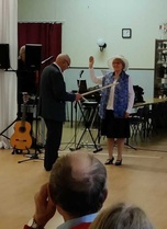 Tuula Kari ja Eino Wägg. Tuula esiintyy Suomi-neitona ja Eino näyttää hänelle kartalta paikkojen nimiä..